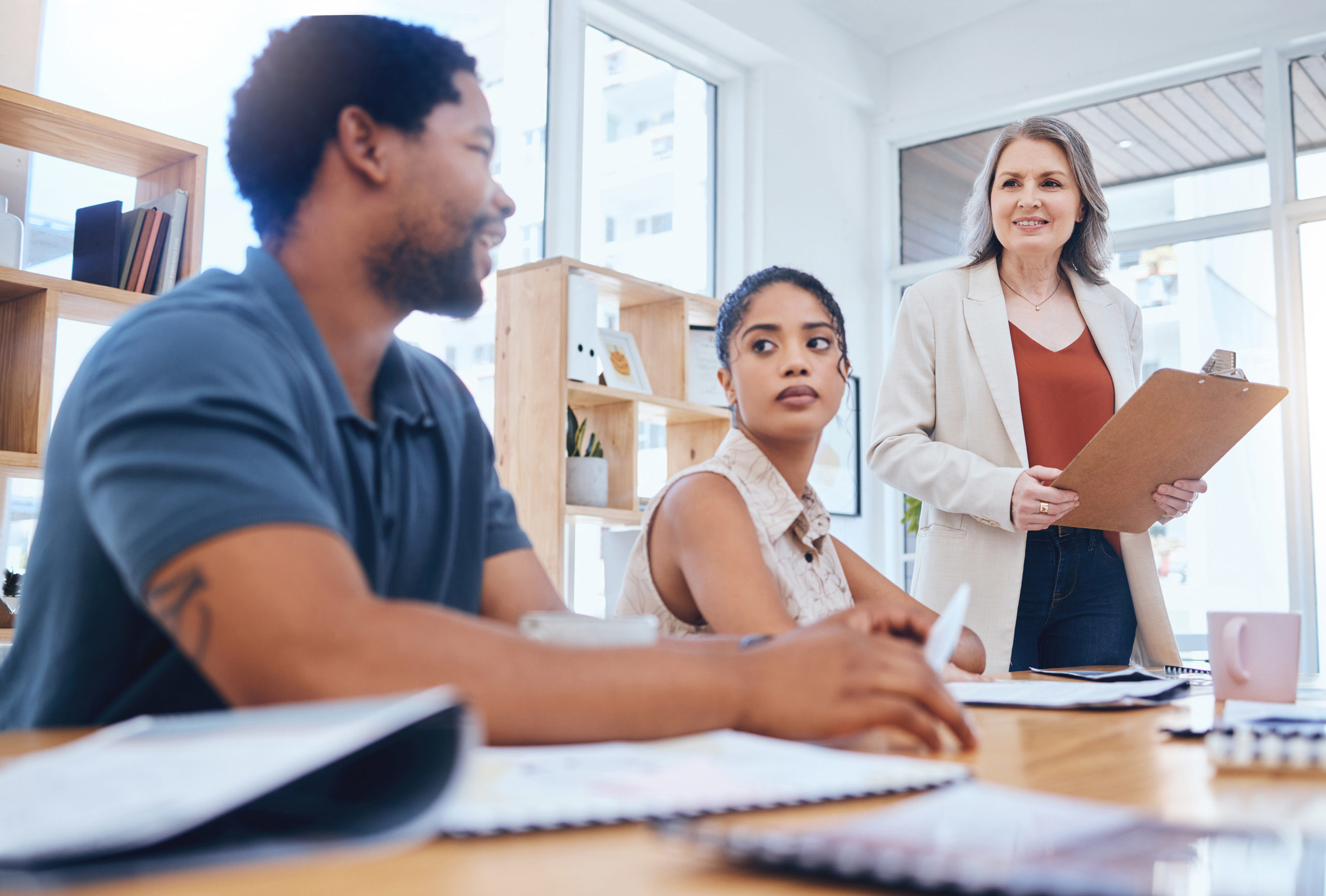 Training, workshop and coaching with a female leader, manager or boss in a meeting with a business man and woman employee. Collaboration, planning and strategy with a team at the office with a mentor.